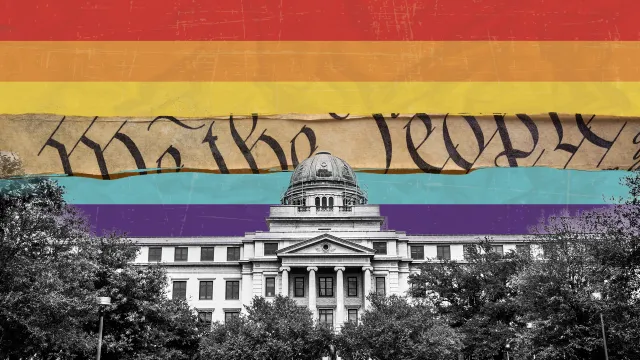 Pride Flag with one stripe removed revealing the words "We the people" from the Constitution with the Texas A&M Academic Building in the foreground.